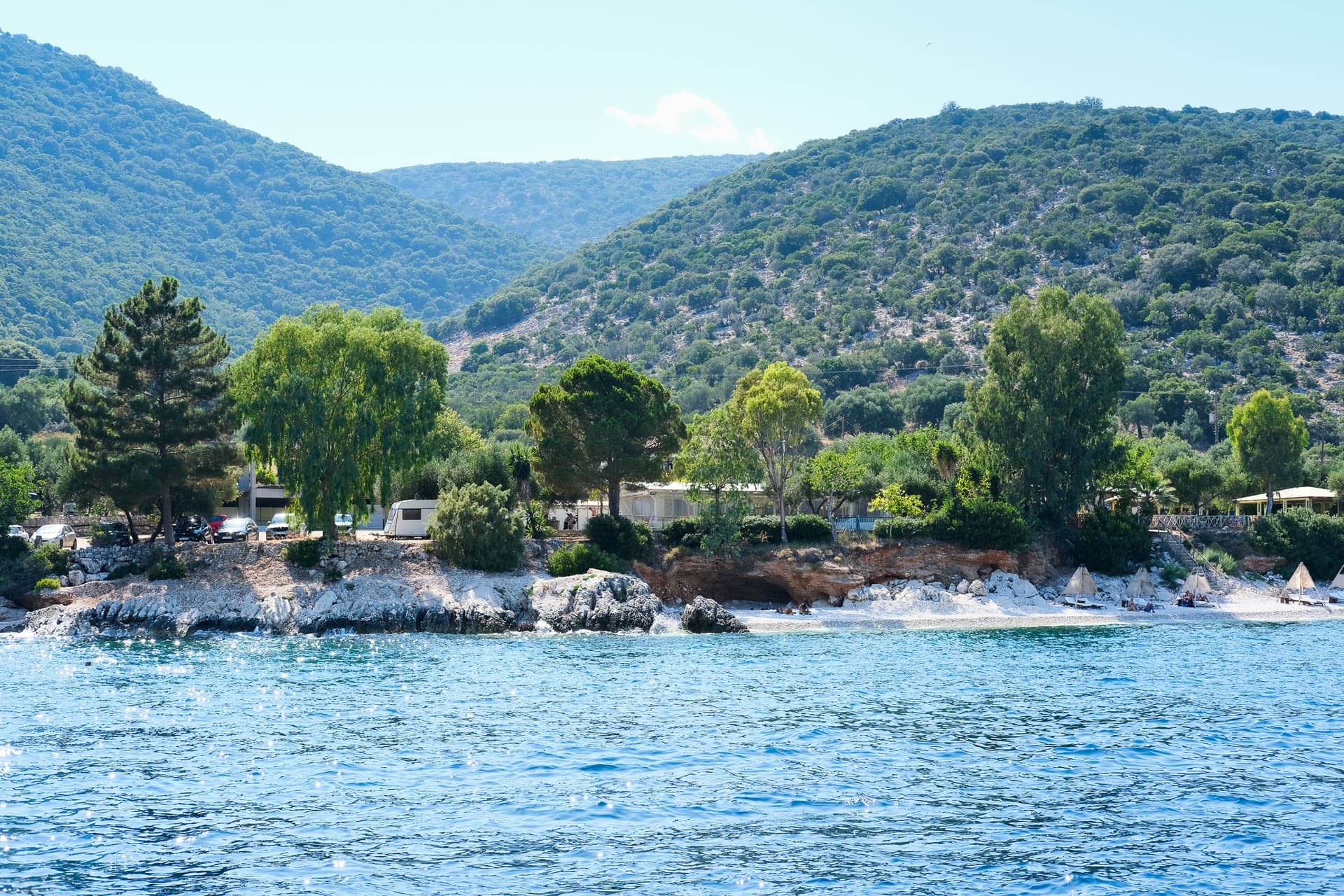 A sheltered bay fringed with pines and olive groves